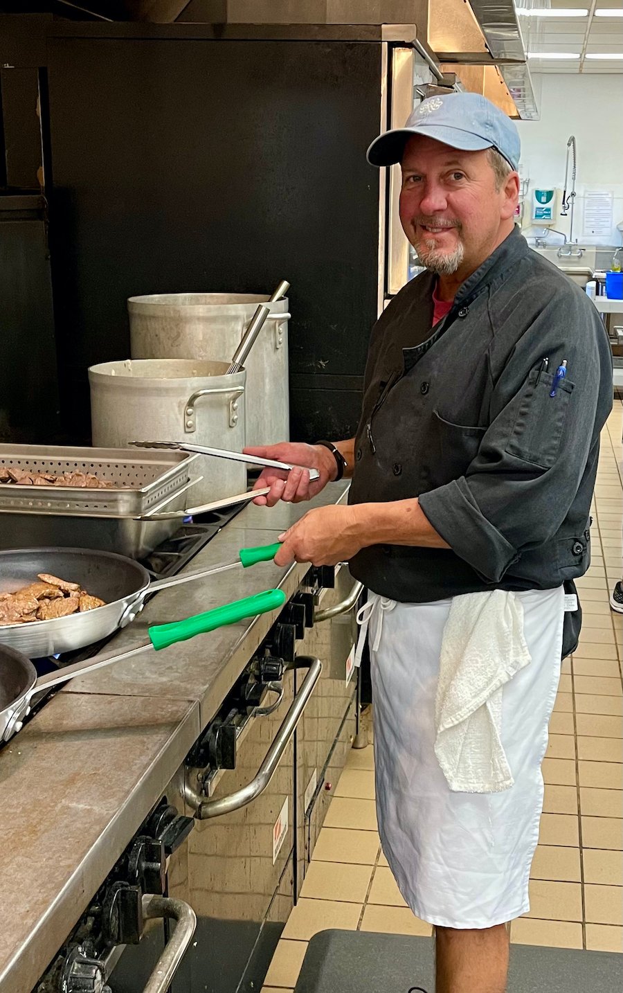 Executive Chef Andrew Spellman cooking in the Delish Delivered kitchen